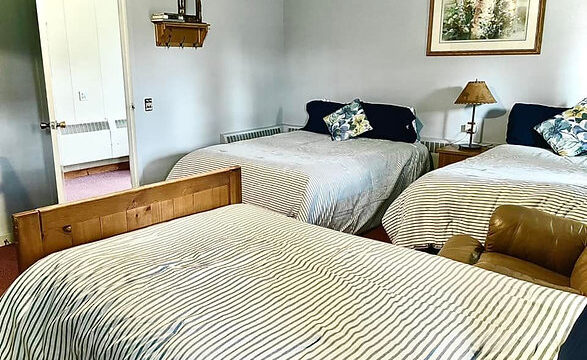A view of one of the rooms at the Alder Inn. It has three beds.