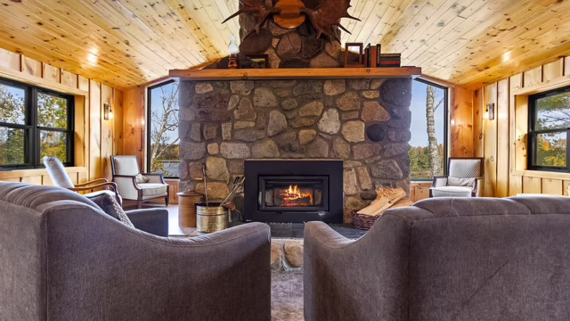 The inside of one of the properties at The Resort on Jasper Lake. It has a fireplace and two comfy chairs.