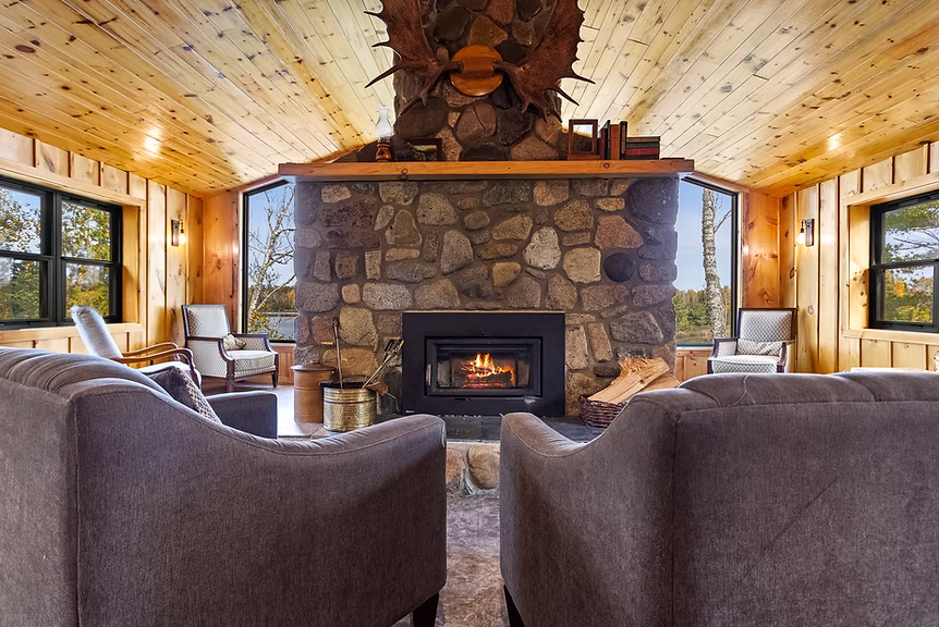 The inside of one of the properties at The Resort on Jasper Lake. It has a fireplace and two comfy chairs.