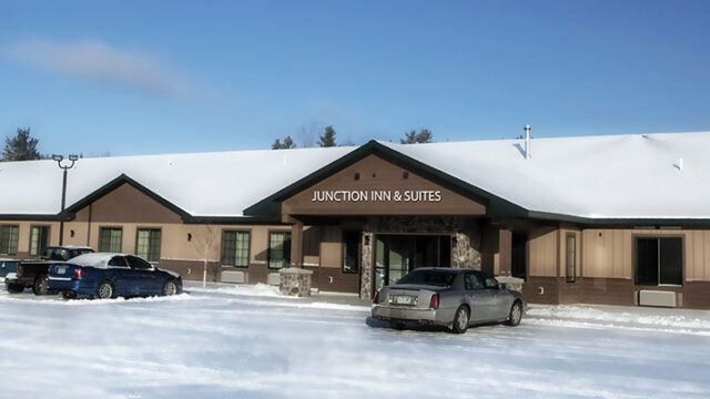The outside of Junction Inn and Suites during the winter.
