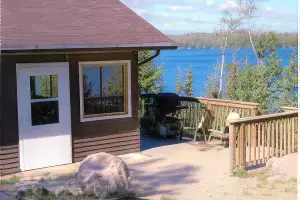 The outside of one of the cabins at La Tourell's. It has a deck and some chairs for lounging.