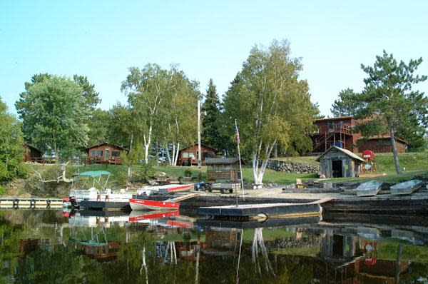 A view of the lake with boats at Packsack Log Cabins.