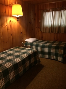 A view of one of the bedrooms in one of the cabins at the Snowbank Lodge. It has two full beds.
