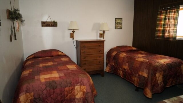 One of the bedrooms in the Spruce cabin at Shagawa Beach Cabins. The Spruce cabin has three bedrooms with full two full beds.
