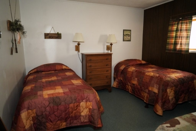 One of the bedrooms in the Spruce cabin at Shagawa Beach Cabins. The Spruce cabin has three bedrooms with full two full beds.