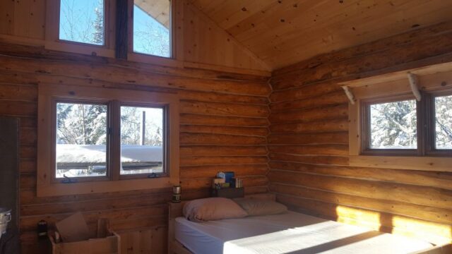 A look at the inside of the Wintergreen cabin. It has a bed and small table.