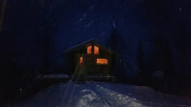 An outside view of the Wintergreen cabin at night.