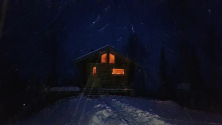 An outside view of the Wintergreen cabin at night.